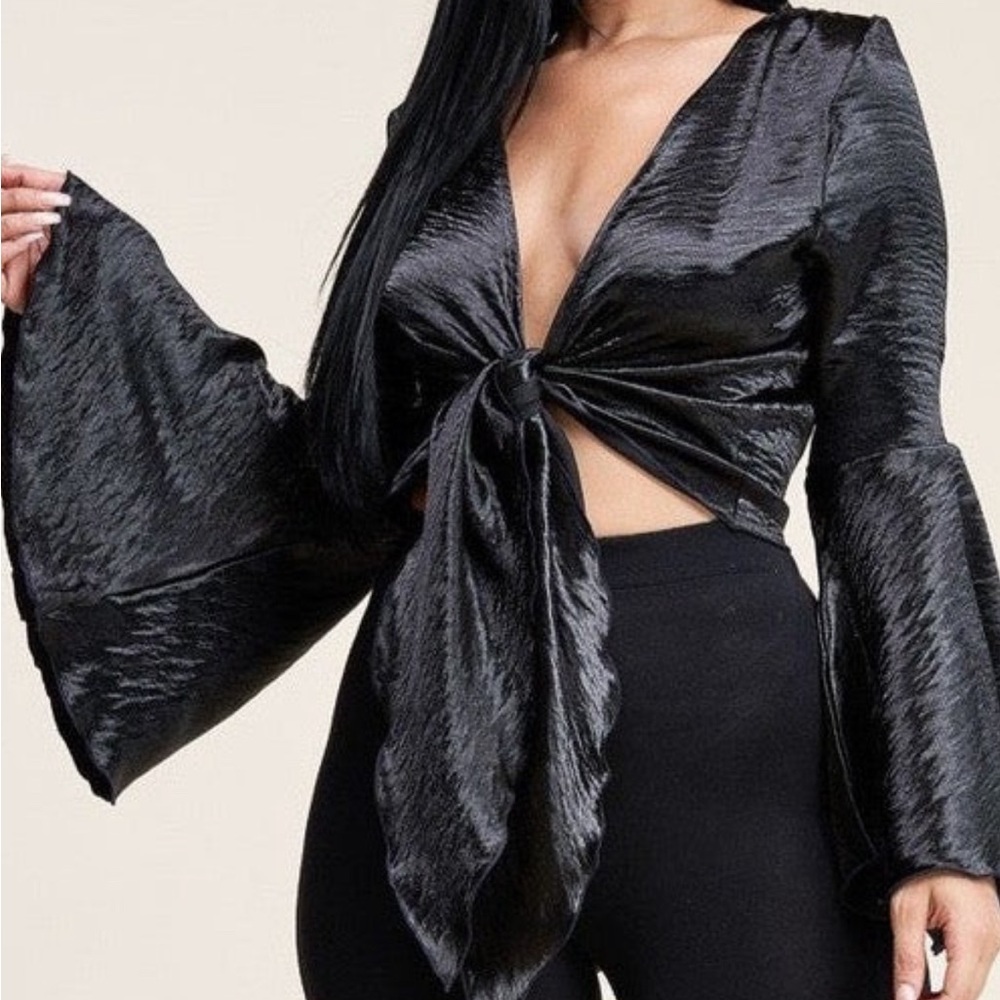 100% Polyester blouse that comes in both black and ivory.